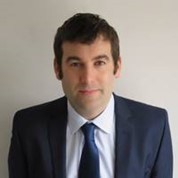 A person in a suit and tie
Description automatically generated with medium confidence