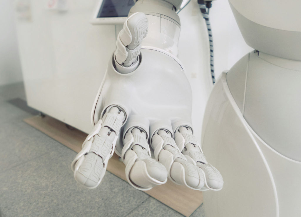 Robot holding out hand in supportive manner. Hand fills frame.